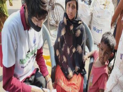 Nitya Foundation volunteer engaging with a family in the community